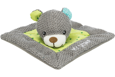Plush toy mouse on a gray blanket with green polka dot border