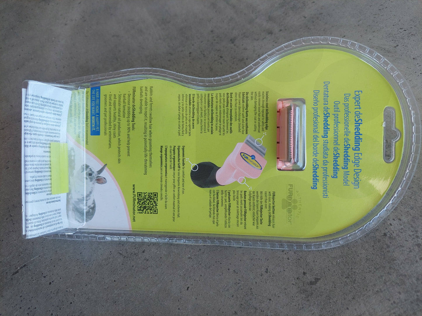 Dog grooming tool packaging on a concrete floor