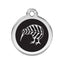 Round metallic tag with black center and white leaf design on a white background