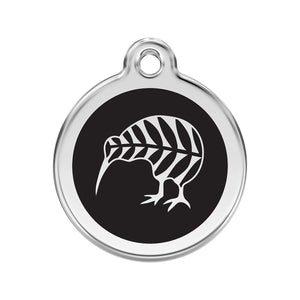 Round metallic tag with black center and white leaf design on a white background