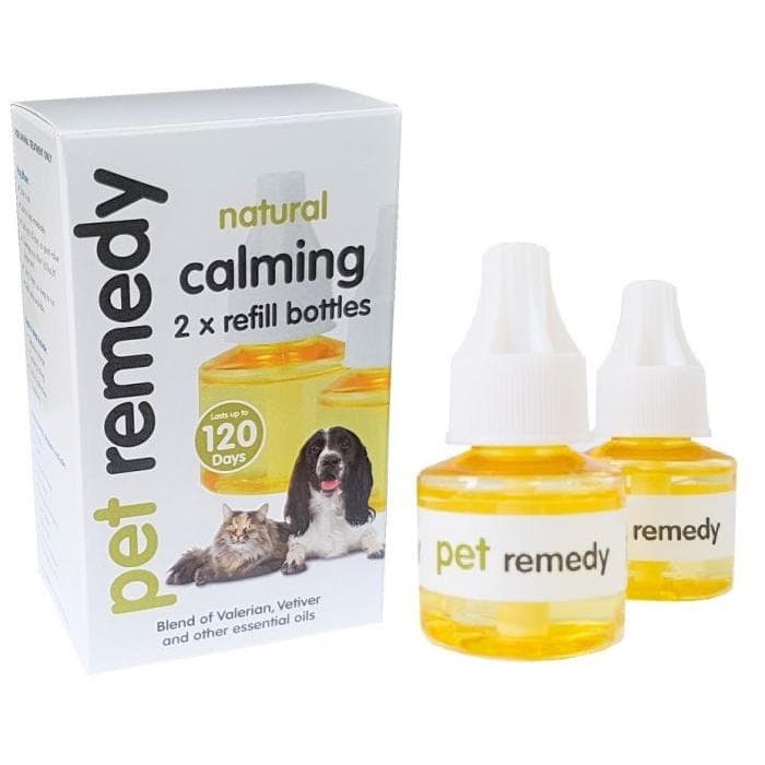 Pet remedy natural calming essential oil refill bottles and packaging box, featuring two amber glass bottles with white dropper caps and a white box with images of a dog and cat.