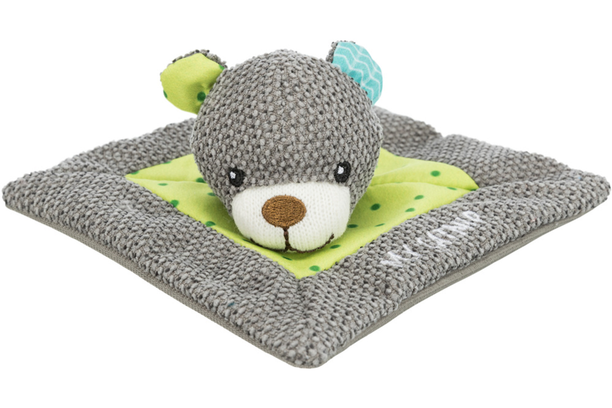 Plush toy mouse on a gray blanket with green polka dot border