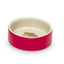 Red pet bowl with a beige interior on a white background
