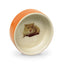 Ceramic hamster wheel with a small animal design on a white background