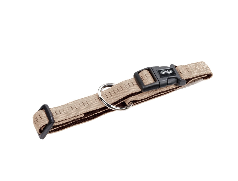 Tan dog collar with a black buckle on a white background