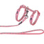Pink dog harness and leash with gray pattern on a white background