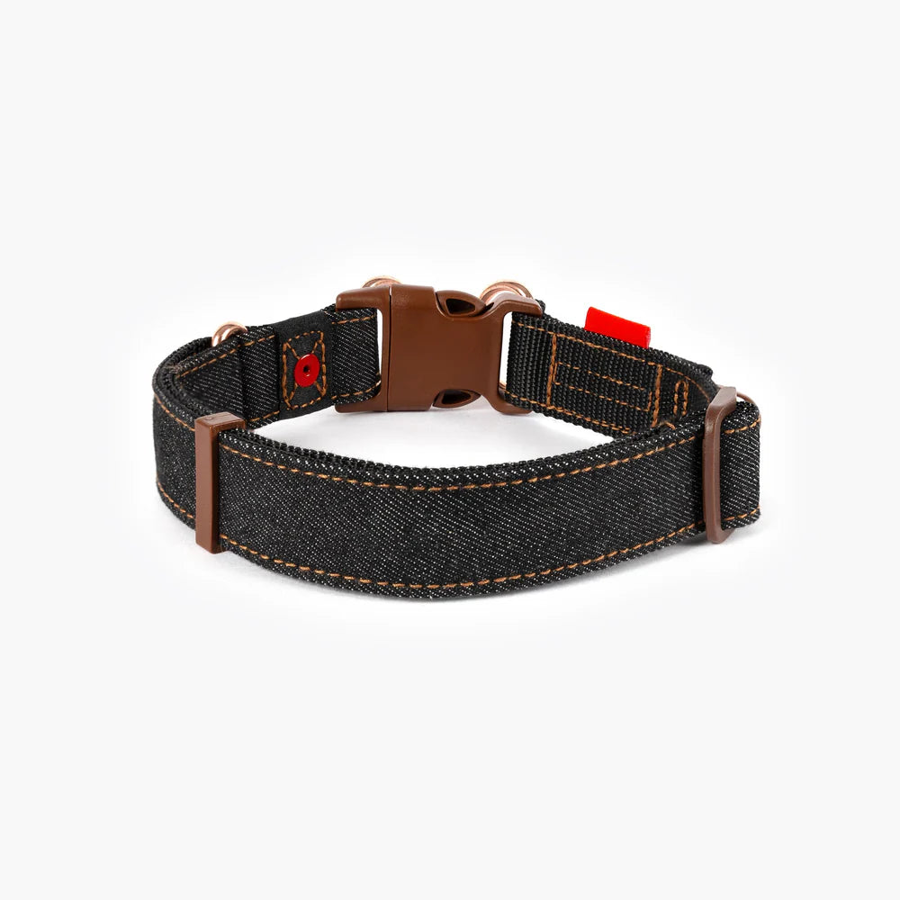 Denim dog collar with brown leather accents on a white background