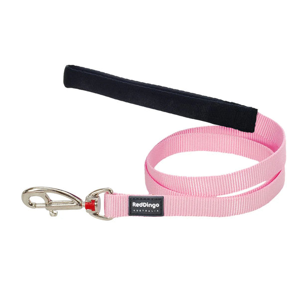 Pink dog leash with black handle and metal clip on a white background