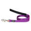 Purple dog leash with black handle and metal clip on a white background