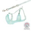 Mint green dog harness and leash set with a visible certification logo on a white background