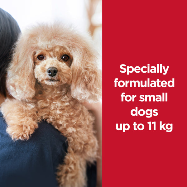 Small dog being held by a person with text about pet food formulation for small dogs up to 11 kg on a red background.