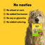 Dog holding a package of 'Animals Like Us' dog treats with a yellow background and text about ingredient claims.