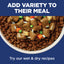 Dog food bowl with dry kibble and wet pet food mix on a blue background