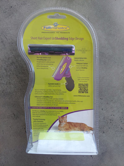 Cat grooming tool in packaging on a concrete floor