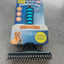 Pet grooming brush with packaging on a concrete surface