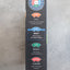 Black rectangular box with colorful labels on a gray surface