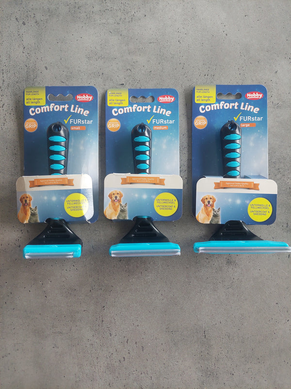 Three packages of Rubis comfort line dog toys on a concrete floor.