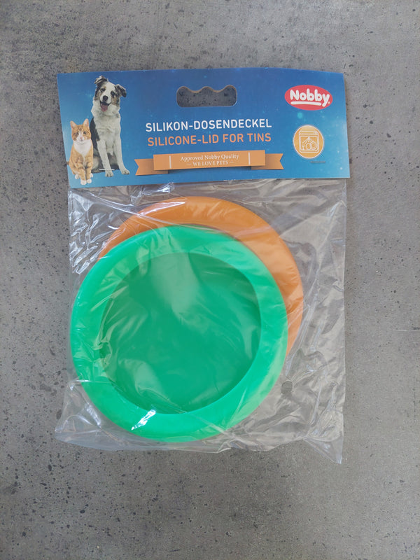 Green silicone lid and packaging on a gray surface