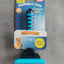 Pet grooming brush with Nobby packaging on a gray surface