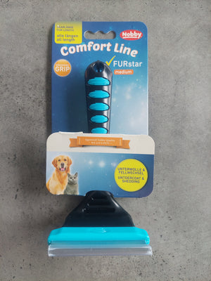 Pet grooming brush with Nobby packaging on a gray surface