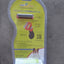 Pet grooming tool packaging on a concrete surface