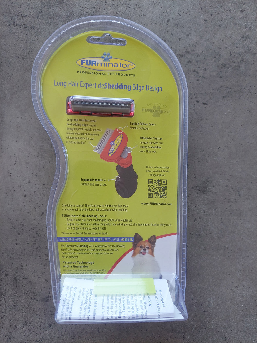 Pet grooming tool with packaging on a concrete surface