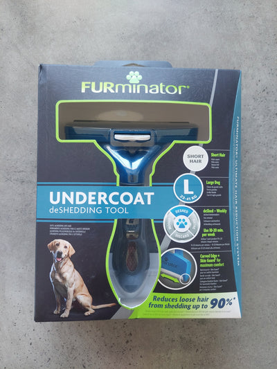 FURminator undercoat shedding tool packaging on a concrete floor
