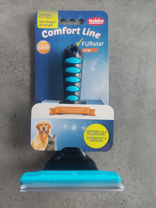 Dog grooming brush with packaging on a concrete surface