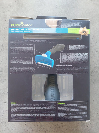 Furminator pet grooming tool packaging on a concrete floor