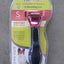 Pet grooming tool with packaging on a concrete surface