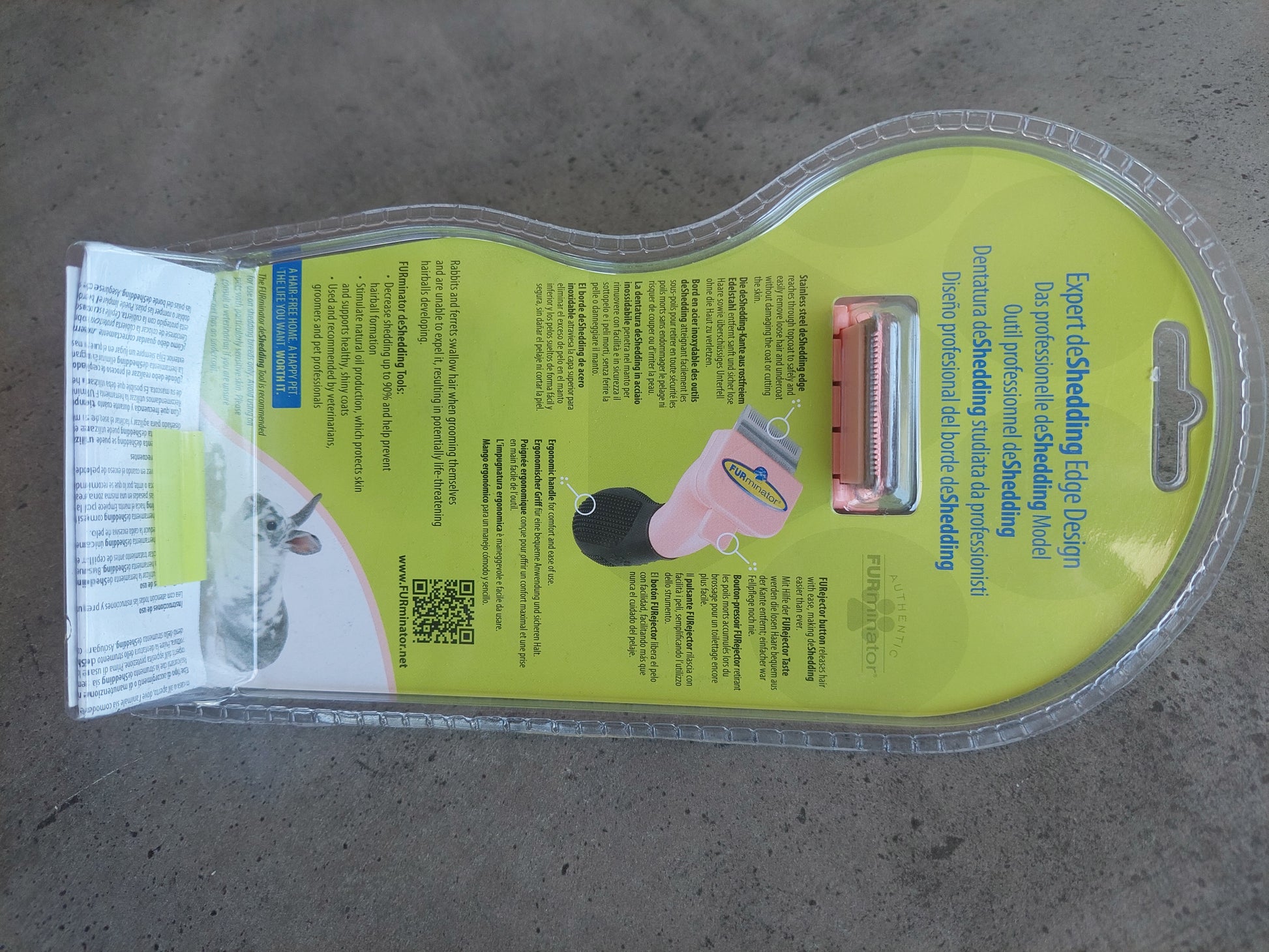 Dog grooming tool packaging on a concrete floor