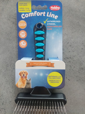 Pet grooming brush with Nobby brand packaging on a concrete surface